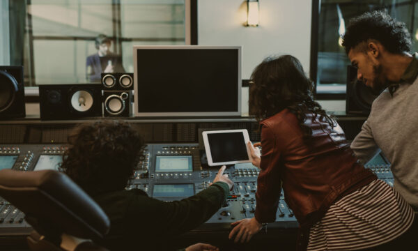 sound producers using tablet together at recording studio sound producers using tablet together at recording studio